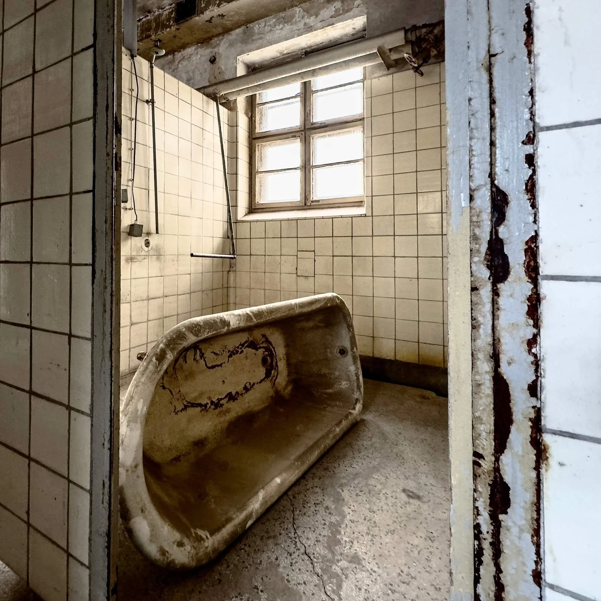 Historic private bath cabins along the upper hallway at the abandoned Stadtbad Lichtenberg in Berlin
