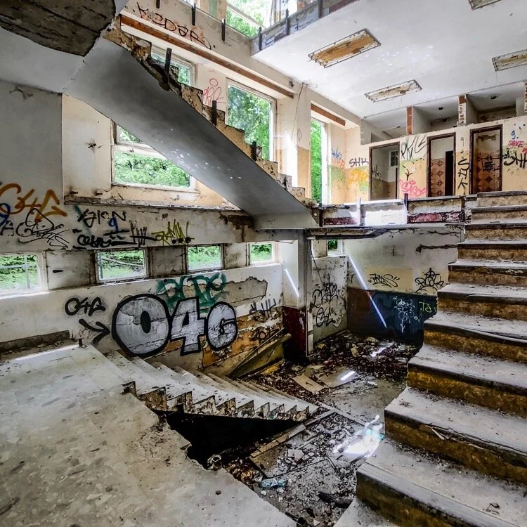 Use a fisheye lens to get this shot if the stairwell in the abandoned residential building