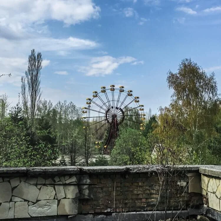 The iconic yellow Ferris wheel rusting away in the overgrown amusement park of Pripyat